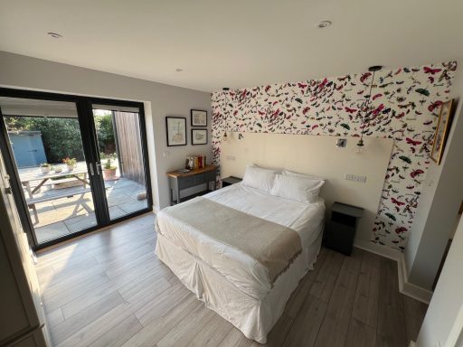 Bedroom with Christian Lacroix insects wallpaper at seaside bed and breakfast hotel in Botany Bay Kent